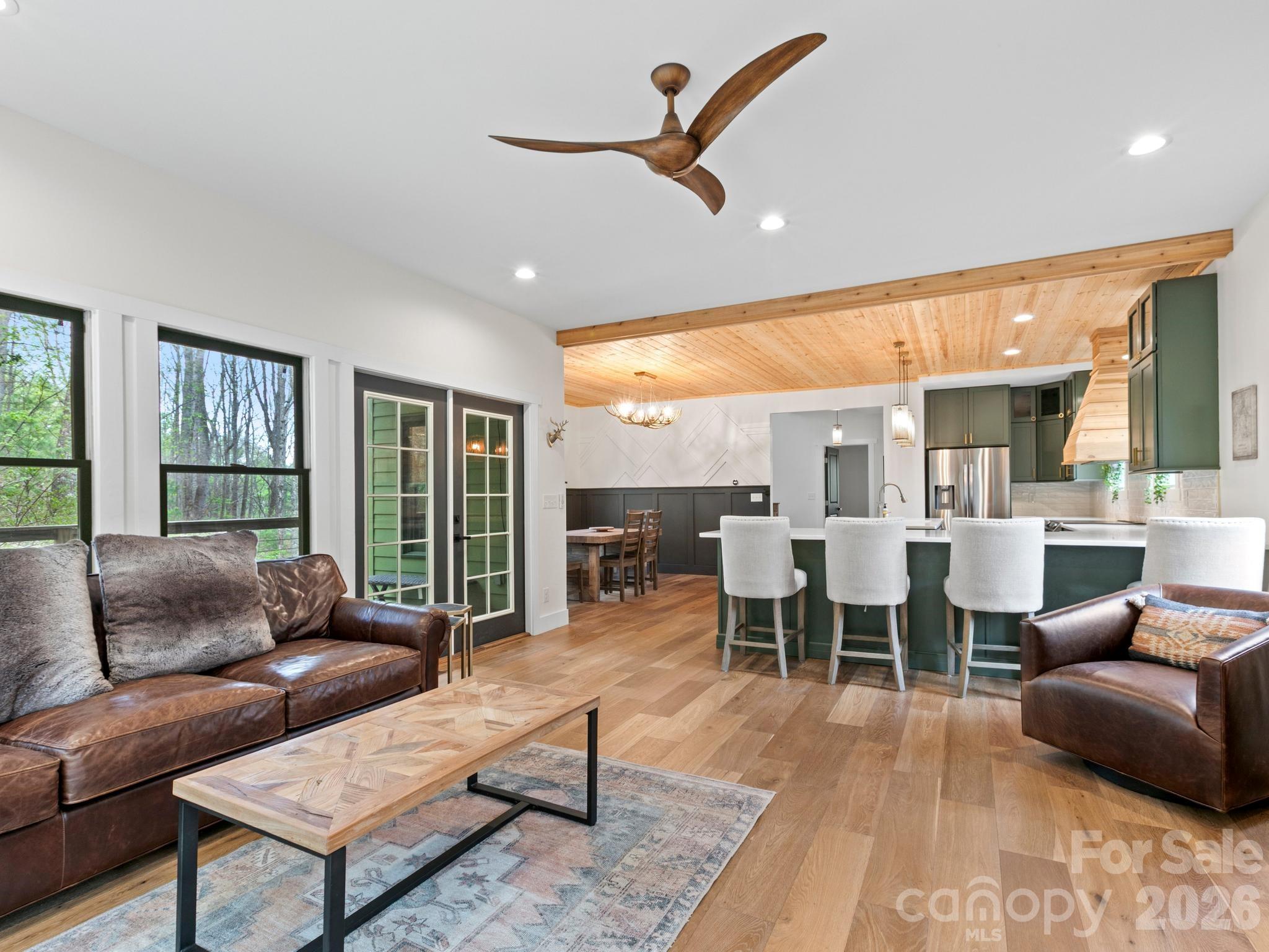 291 Webb Cove Road Asheville, NC 28804 - Photo 6 of 34 a living room with furniture wooden floor dining table and a large window