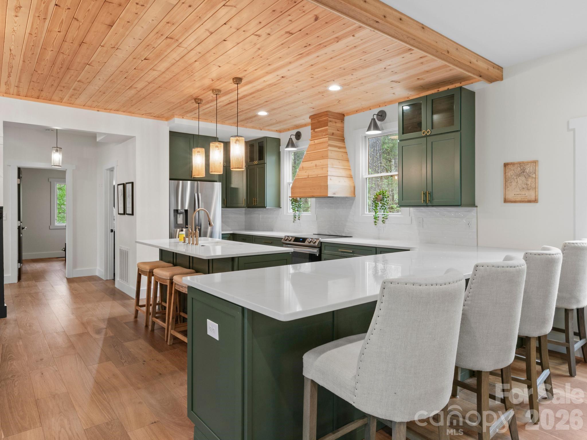 291 Webb Cove Road Asheville, NC 28804 - Photo 7 of 34 a kitchen with a table chairs sink and cabinets