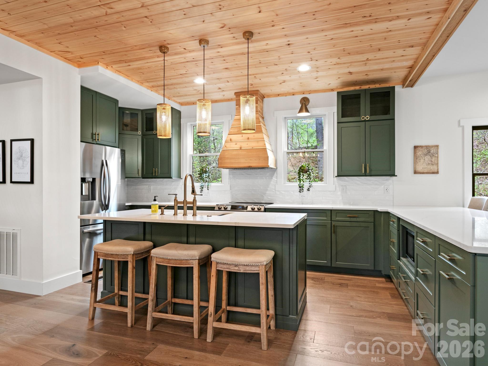 291 Webb Cove Road Asheville, NC 28804 - Photo 8 of 34 a kitchen with a table chairs sink and cabinets