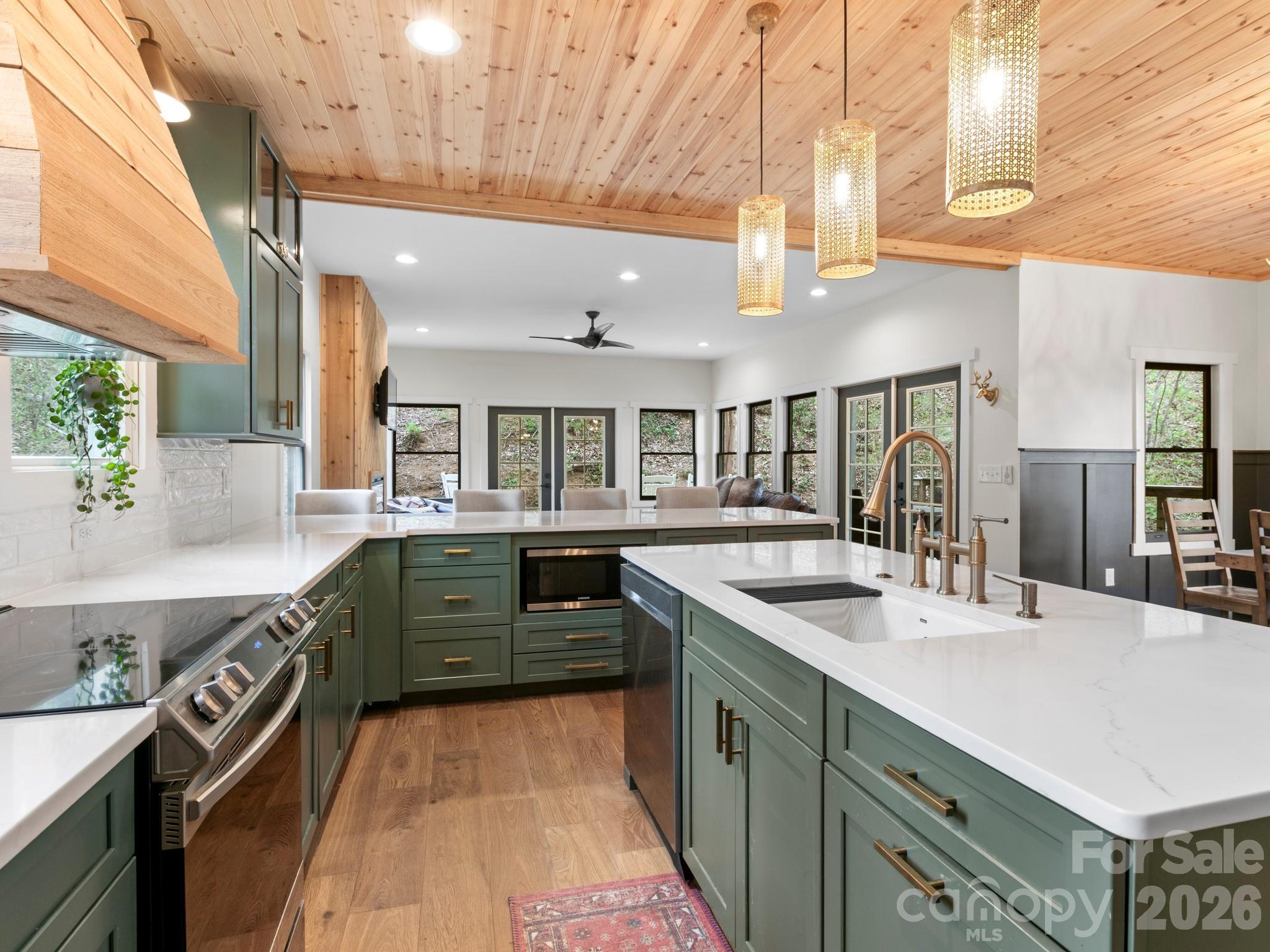 291 Webb Cove Road Asheville, NC 28804 - Photo 10 of 34 a kitchen with stainless steel appliances granite countertop a sink and stove
