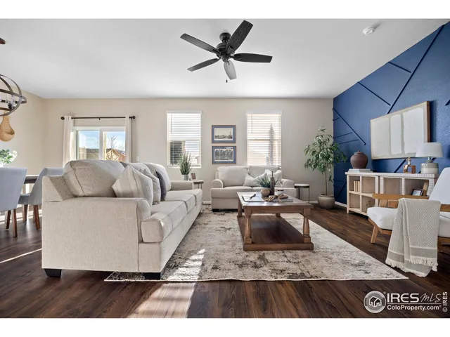 a living room with furniture a rug and kitchen view
