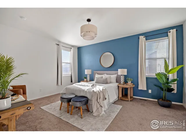 a bedroom with bed and a potted plant