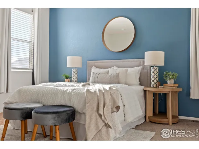 a bedroom with a bed and a lamp