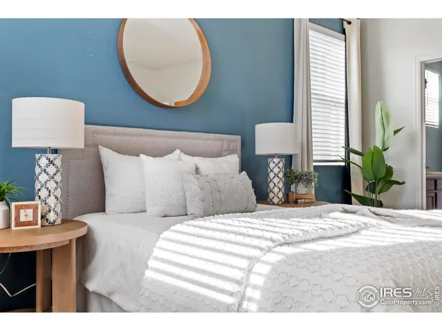 a bedroom with a bed and a lamp