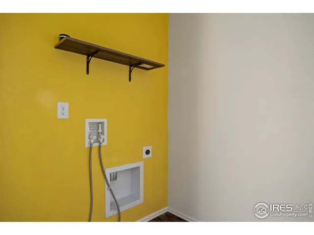 a view of a bathroom with a shower and a wall