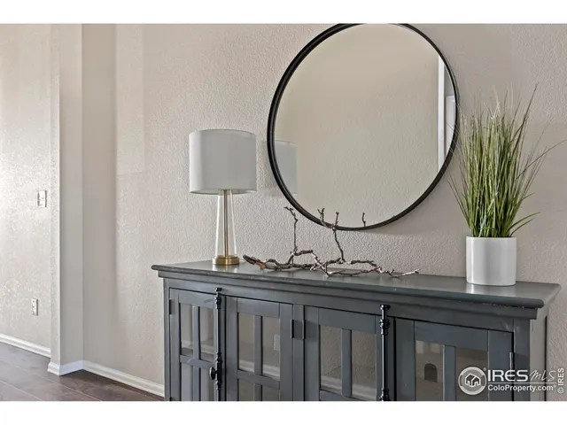a bathroom with a sink a mirror and a potted plant