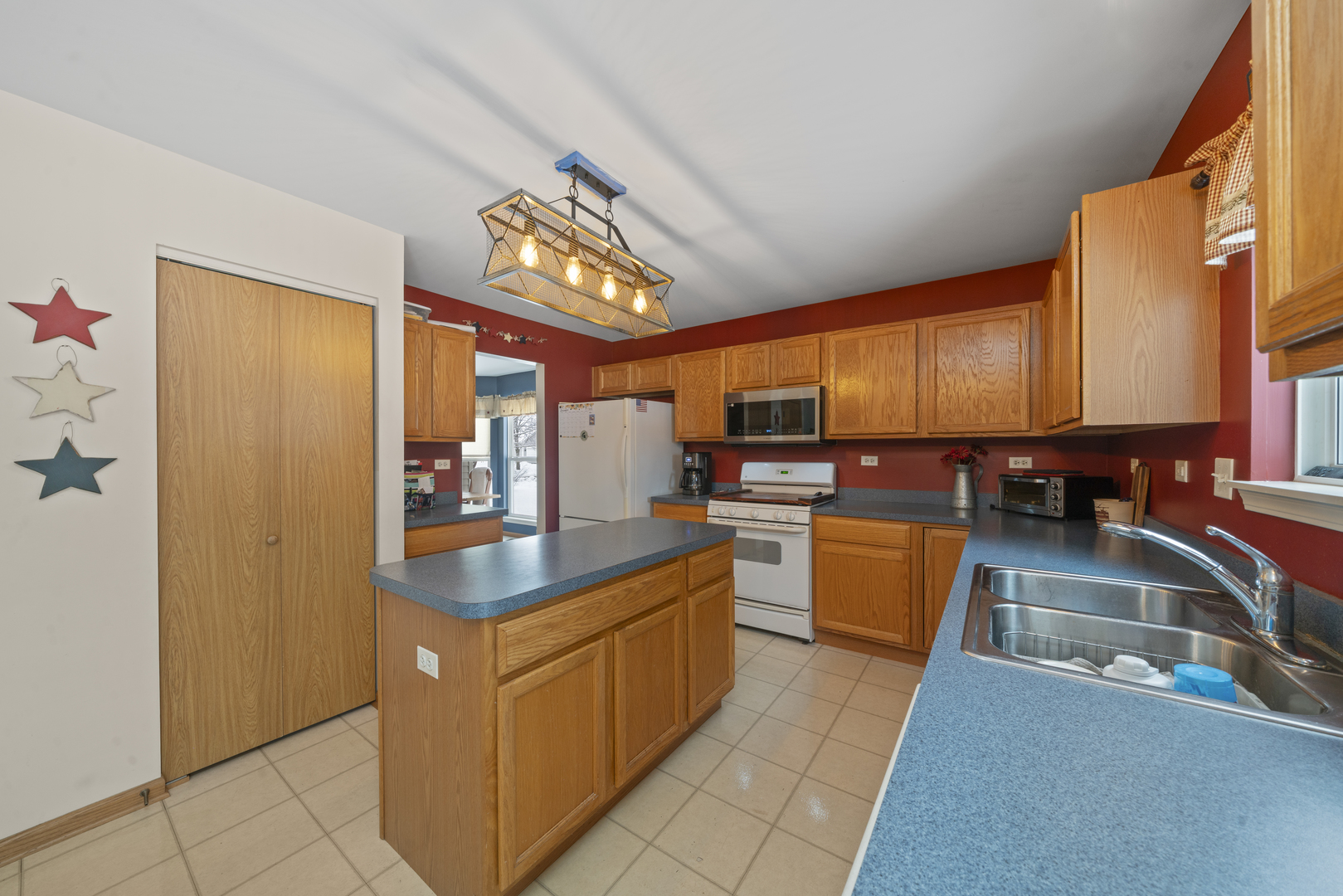 3505 Bailey Street Plano, IL 60545 - Photo 12 of 31 a kitchen with stainless steel appliances granite countertop a sink counter space cabinets and a stove
