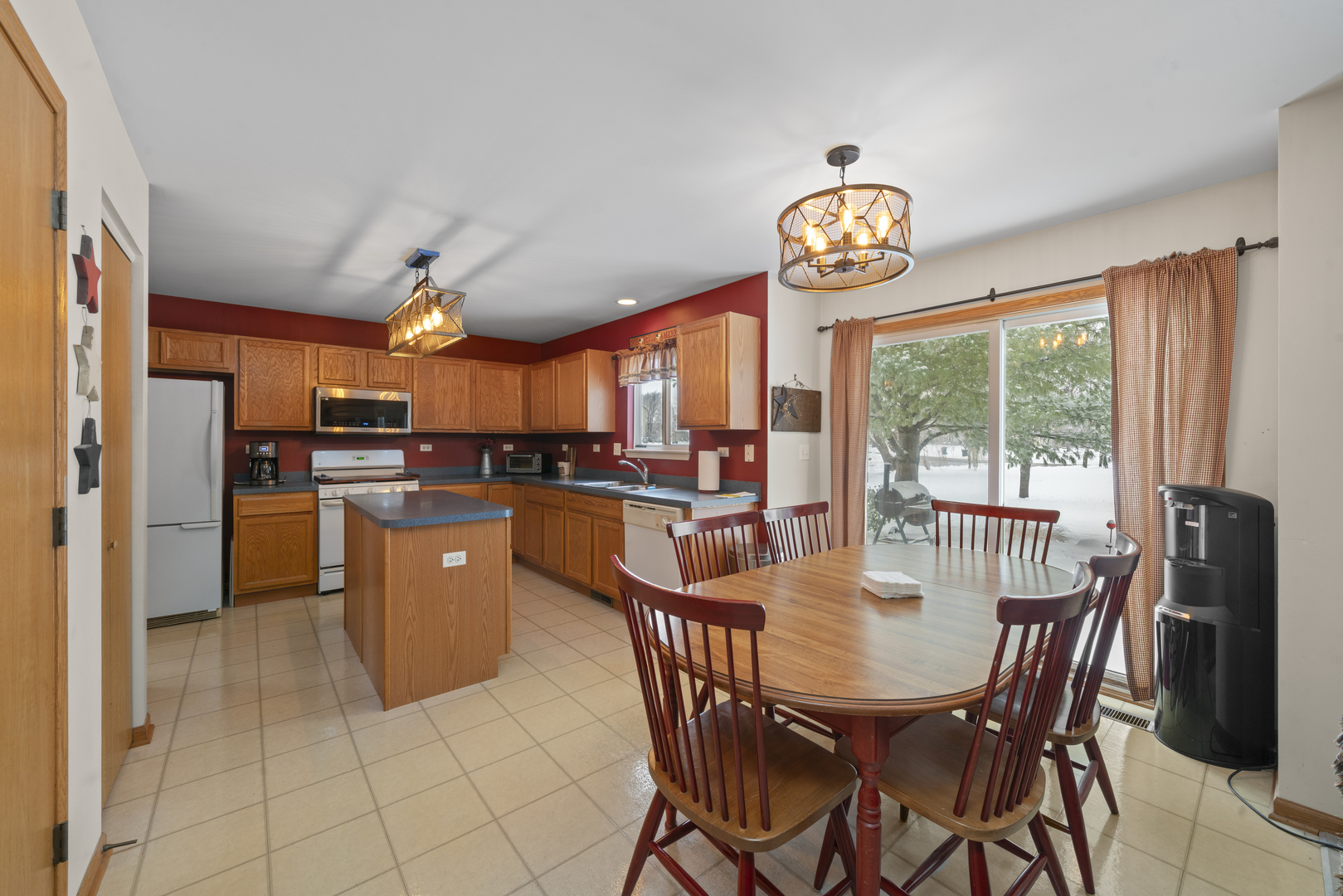 3505 Bailey Street Plano, IL 60545 - Photo 8 of 31 a dining room with furniture a kitchen view and a chandelier
