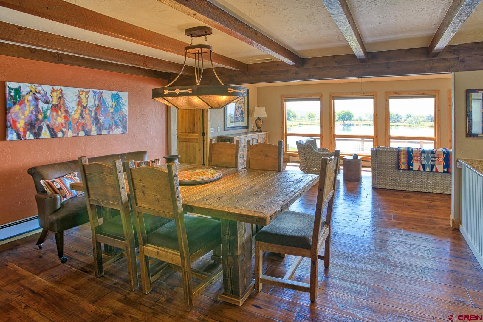1499 Southwest Melinda Road Cedaredge, CO 81413 - Photo 13 of 35 a dining room with furniture a chandelier and wooden floor