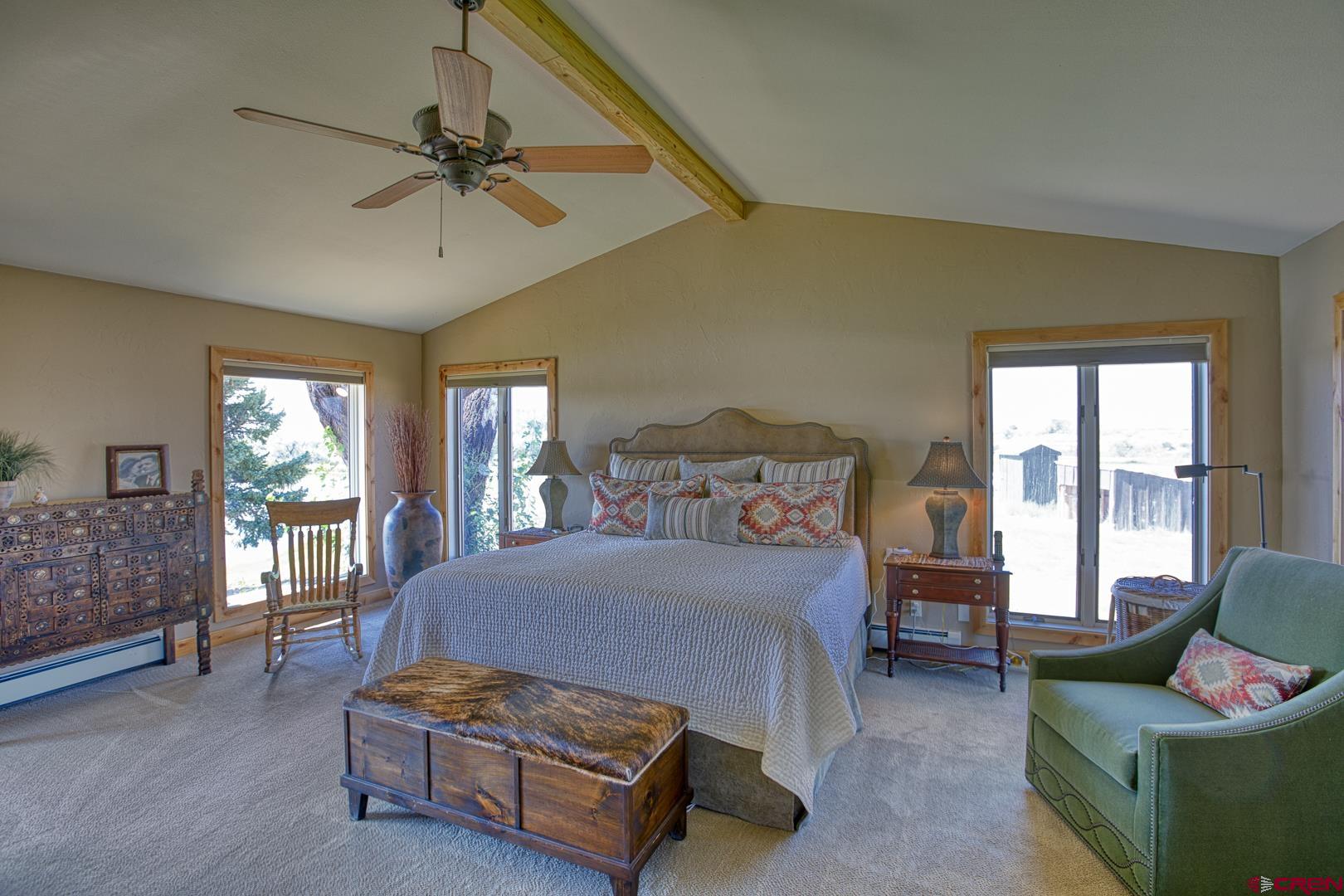 1499 Southwest Melinda Road Cedaredge, CO 81413 - Photo 18 of 35 a bedroom with a bed and a couch