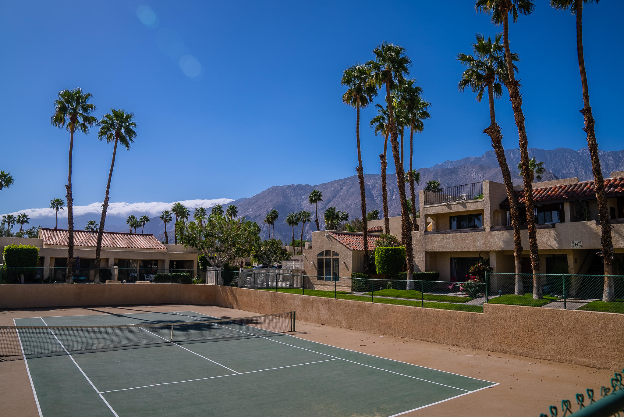 200 East Racquet Club Road, Unit 24 Palm Springs, CA 92262 - Photo 50 of 58 a front view of a building with palm trees