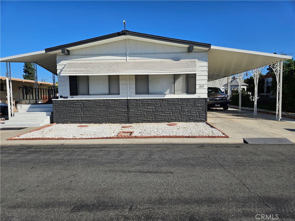 1327 Woodbrook Square Corona, CA 92882 - Photo 1 of 14 a front view of a house with a garage