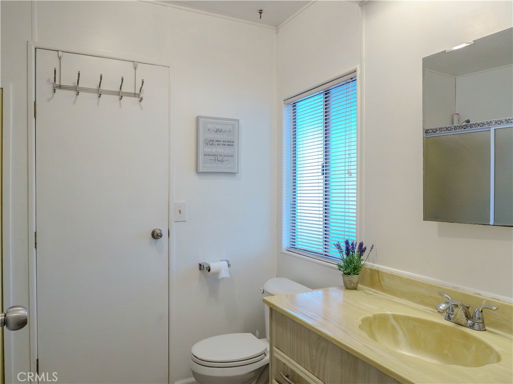1327 Woodbrook Square Corona, CA 92882 - Photo 11 of 21 a bathroom with a granite countertop sink toilet and shower