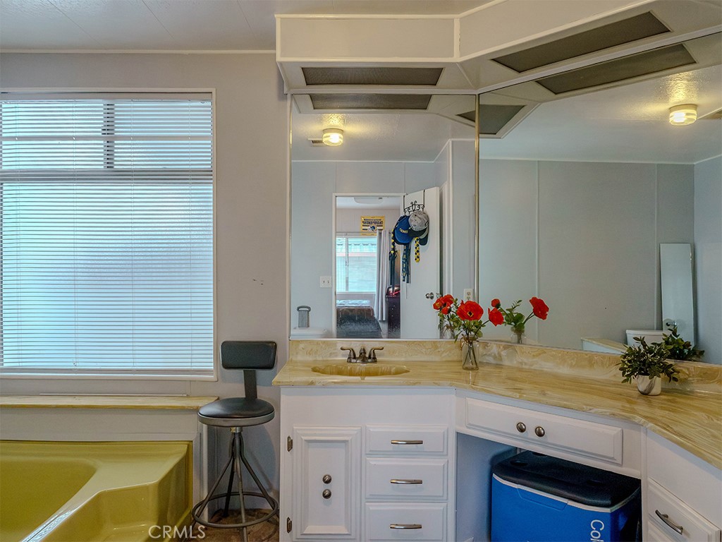 1327 Woodbrook Square Corona, CA 92882 - Photo 14 of 21 a bathroom with a sink and a mirror