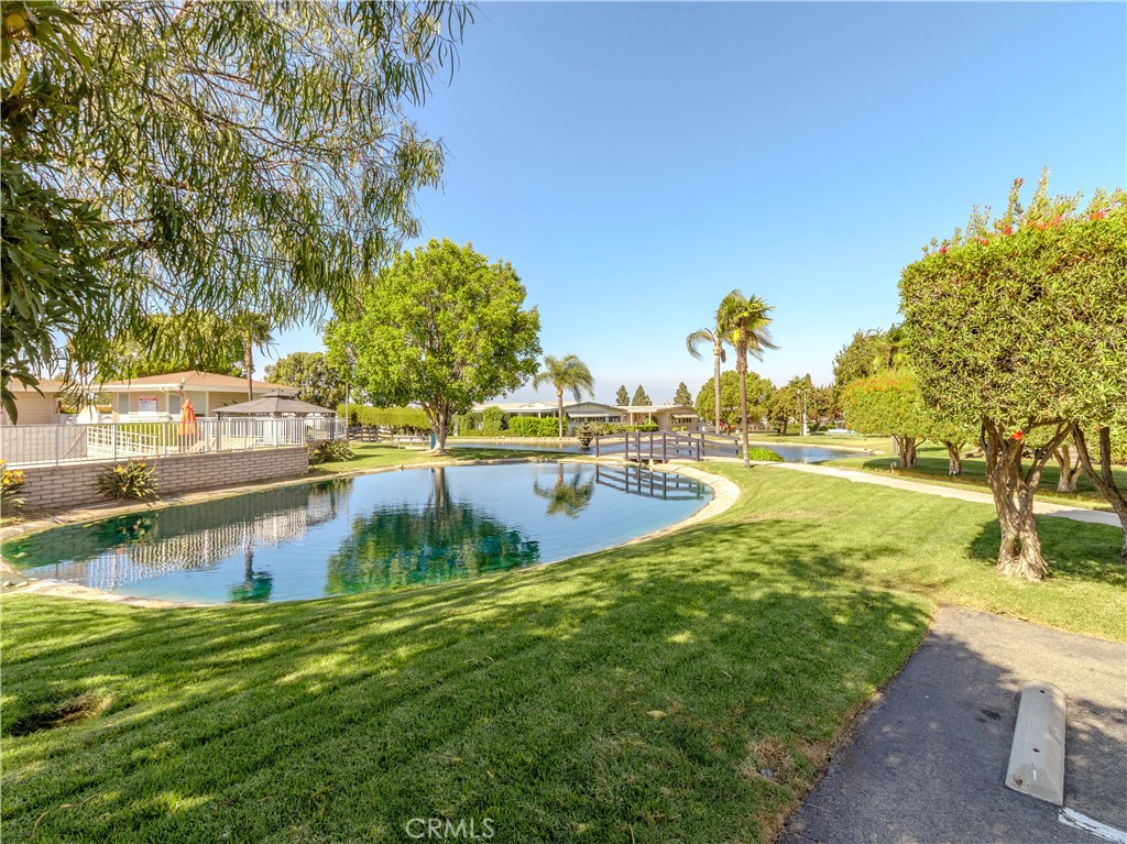 1327 Woodbrook Square Corona, CA 92882 - Photo 20 of 21 a view of a swimming pool with a yard