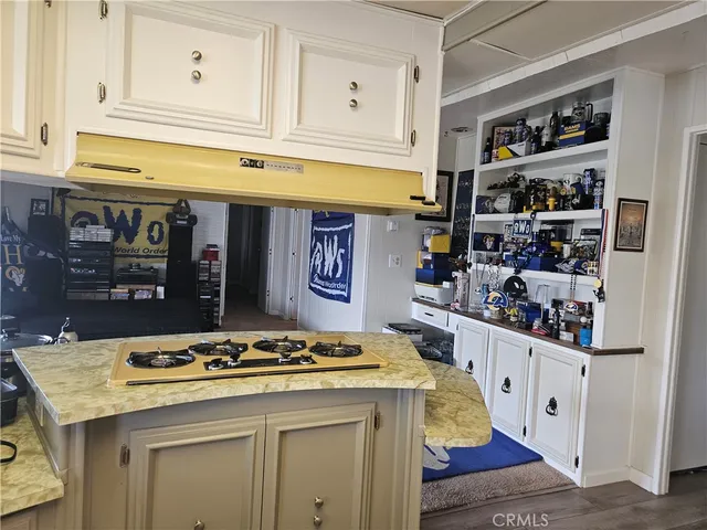 a kitchen with stainless steel appliances granite countertop a sink and cabinets
