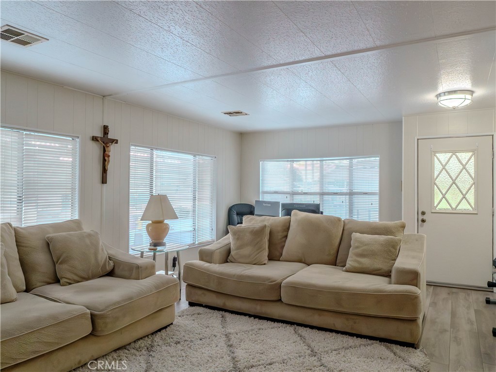 1327 Woodbrook Square Corona, CA 92882 - Photo 4 of 21 a living room with furniture and a large window