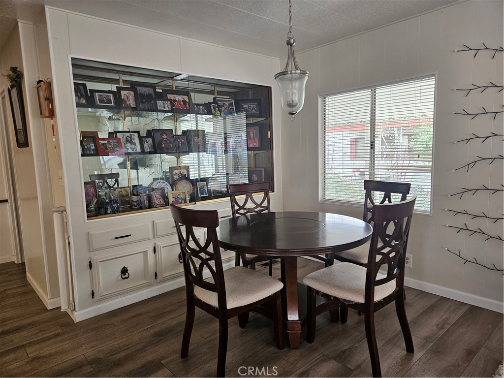 1327 Woodbrook Square Corona, CA 92882 - Photo 4 of 14 a view of a dining room with furniture window and wooden floor
