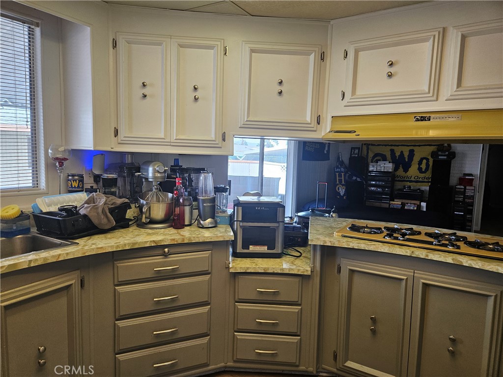 1327 Woodbrook Square Corona, CA 92882 - Photo 5 of 14 a kitchen with stainless steel appliances granite countertop a stove and cabinets