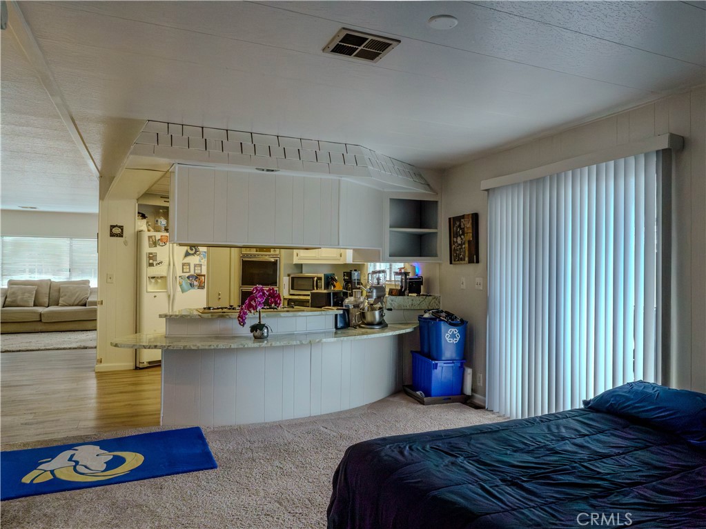 1327 Woodbrook Square Corona, CA 92882 - Photo 8 of 21 a bedroom with furniture and a flat screen tv