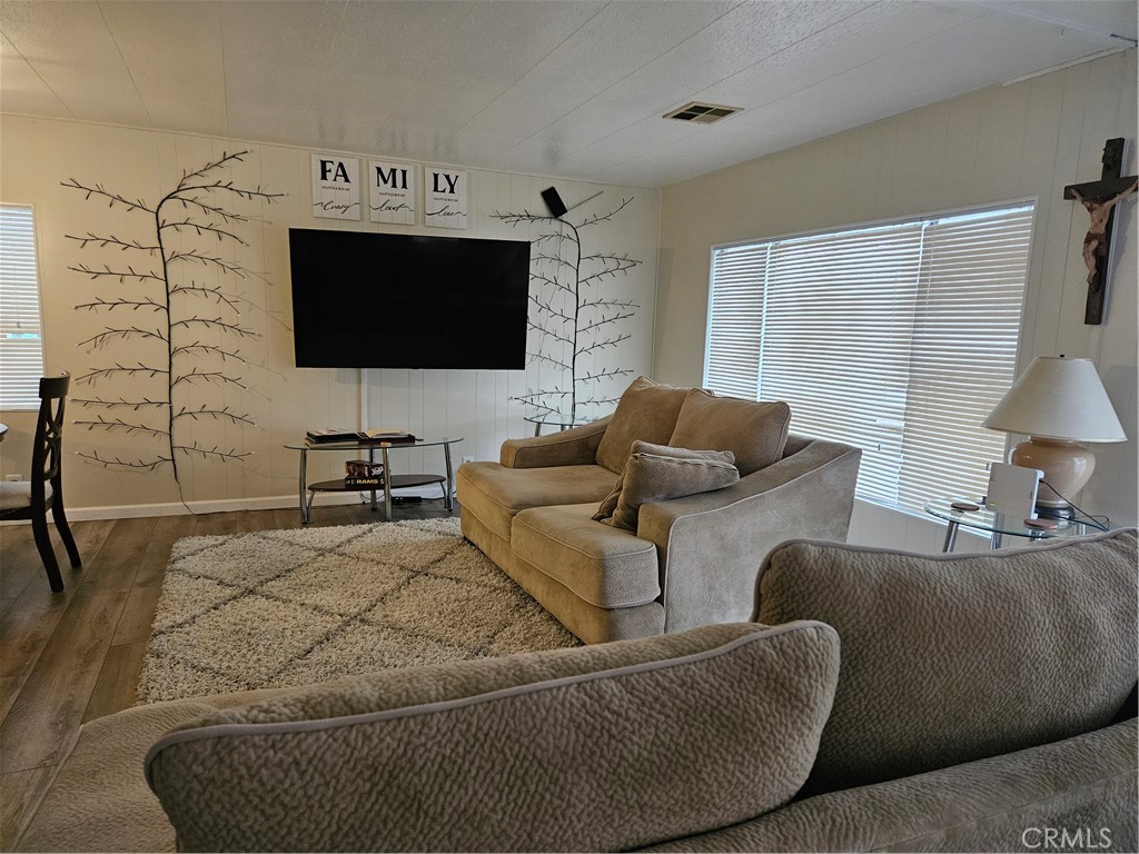 1327 Woodbrook Square Corona, CA 92882 - Photo 8 of 14 a living room with furniture and a flat screen tv