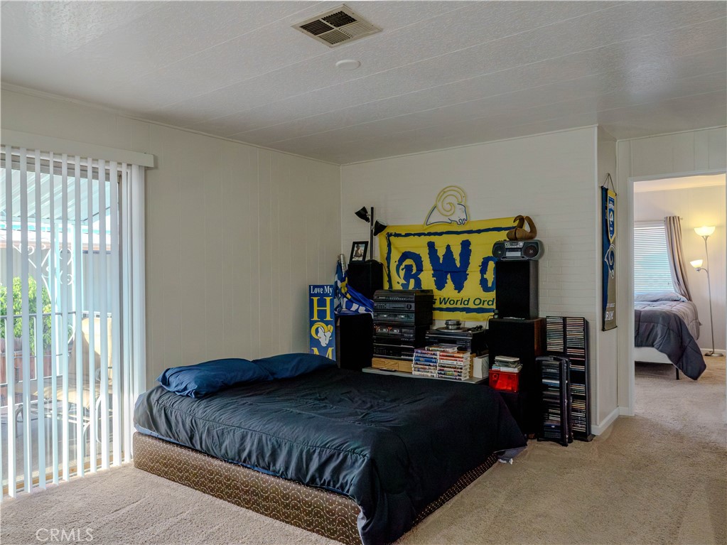 1327 Woodbrook Square Corona, CA 92882 - Photo 9 of 21 a bedroom with a bed and a tv