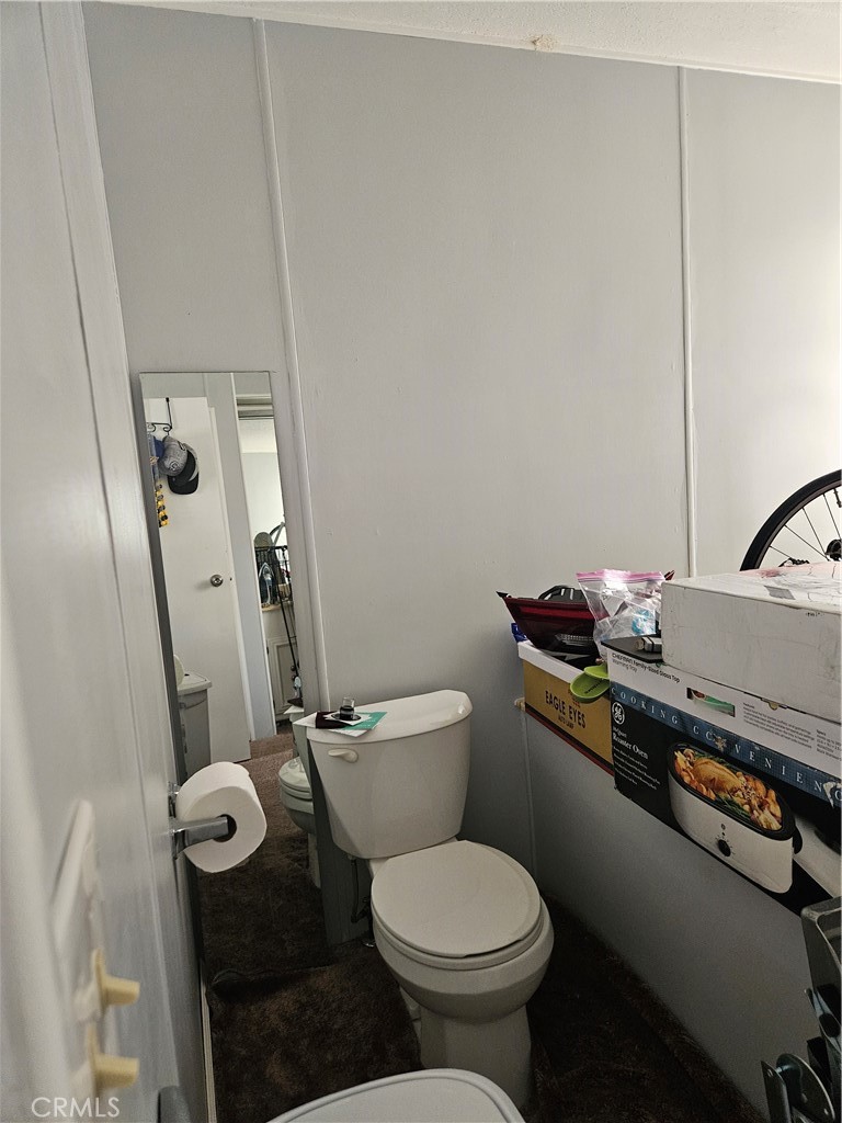 1327 Woodbrook Square Corona, CA 92882 - Photo 10 of 14 a bathroom with a granite countertop toilet sink and mirror