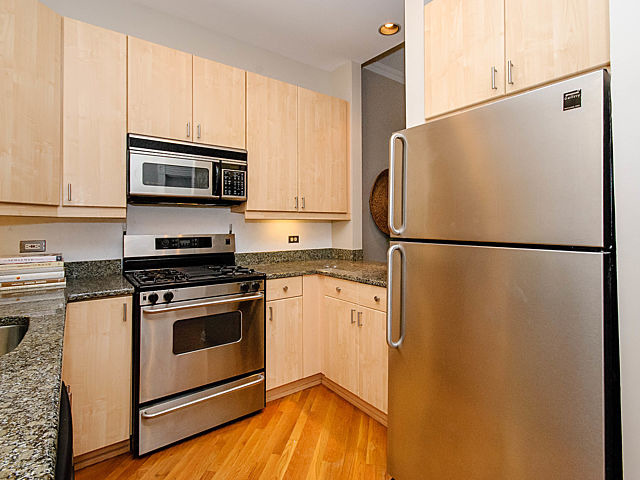 2730 North Racine Avenue, Unit 2S Chicago, IL 60614 - Photo 4 of 18 a kitchen with stainless steel appliances a refrigerator stove and microwave