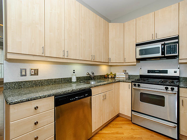 2730 North Racine Avenue, Unit 2S Chicago, IL 60614 - Photo 5 of 18 a kitchen with granite countertop cabinets stainless steel appliances and a sink