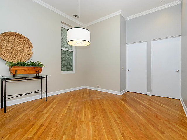 2730 North Racine Avenue, Unit 2S Chicago, IL 60614 - Photo 7 of 18 a view of an empty room with a window and wooden floor