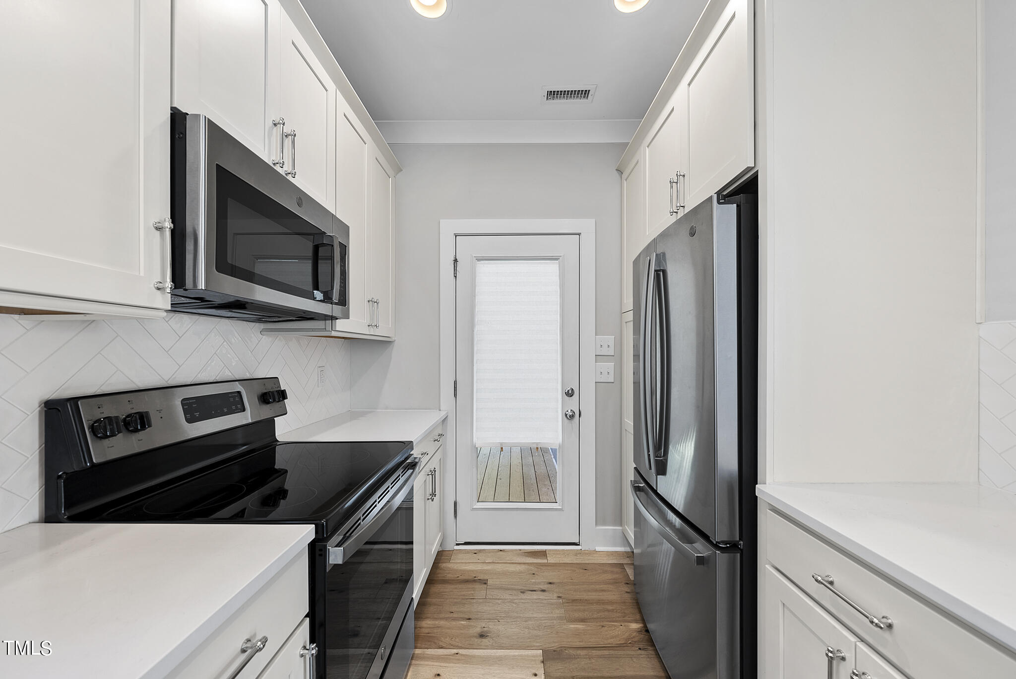 421 Como Drive Raleigh, NC 27610 - Photo 11 of 28 a kitchen with a refrigerator stove and microwave