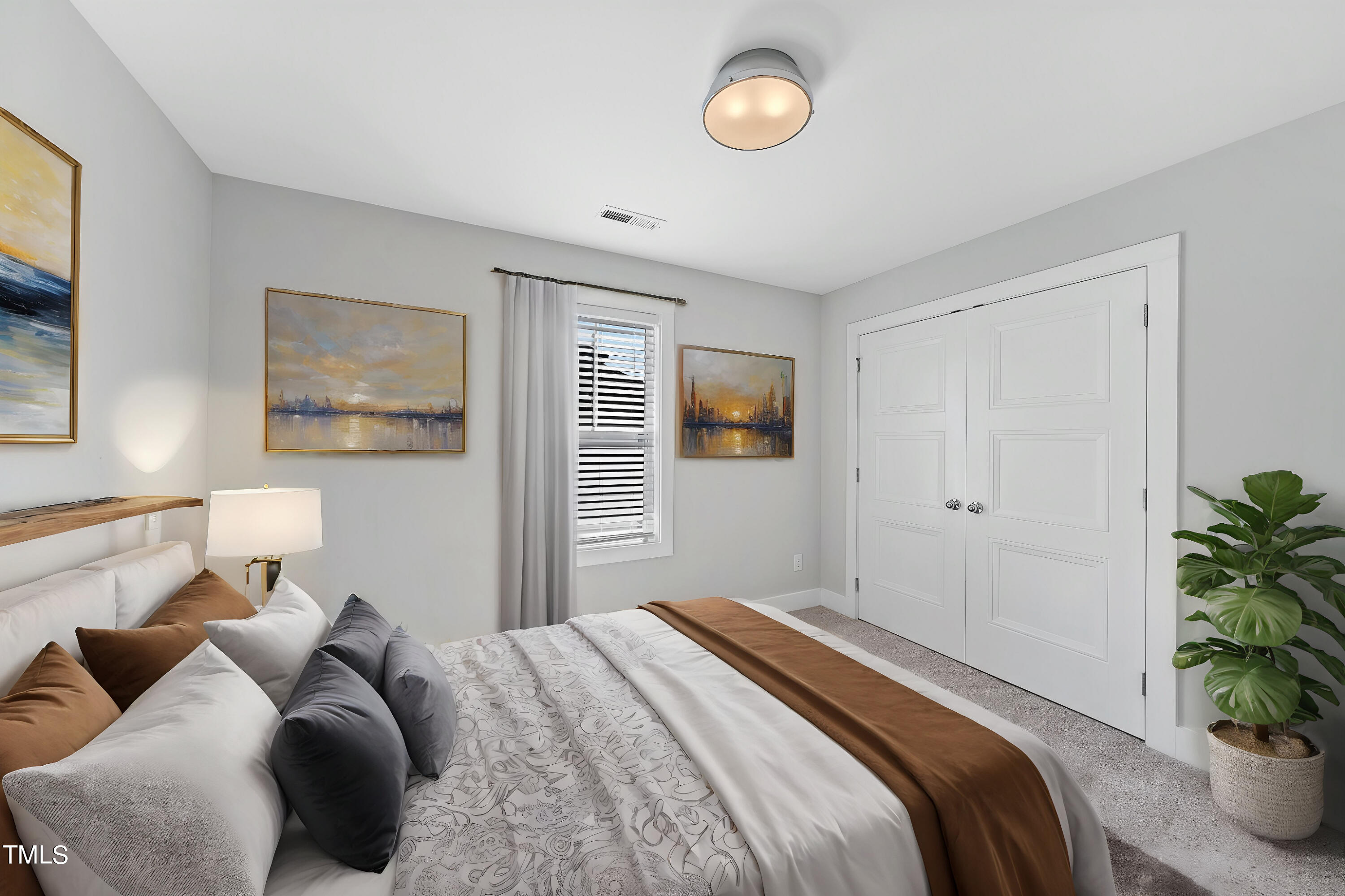 421 Como Drive Raleigh, NC 27610 - Photo 17 of 28 a bedroom with bed and a potted plant