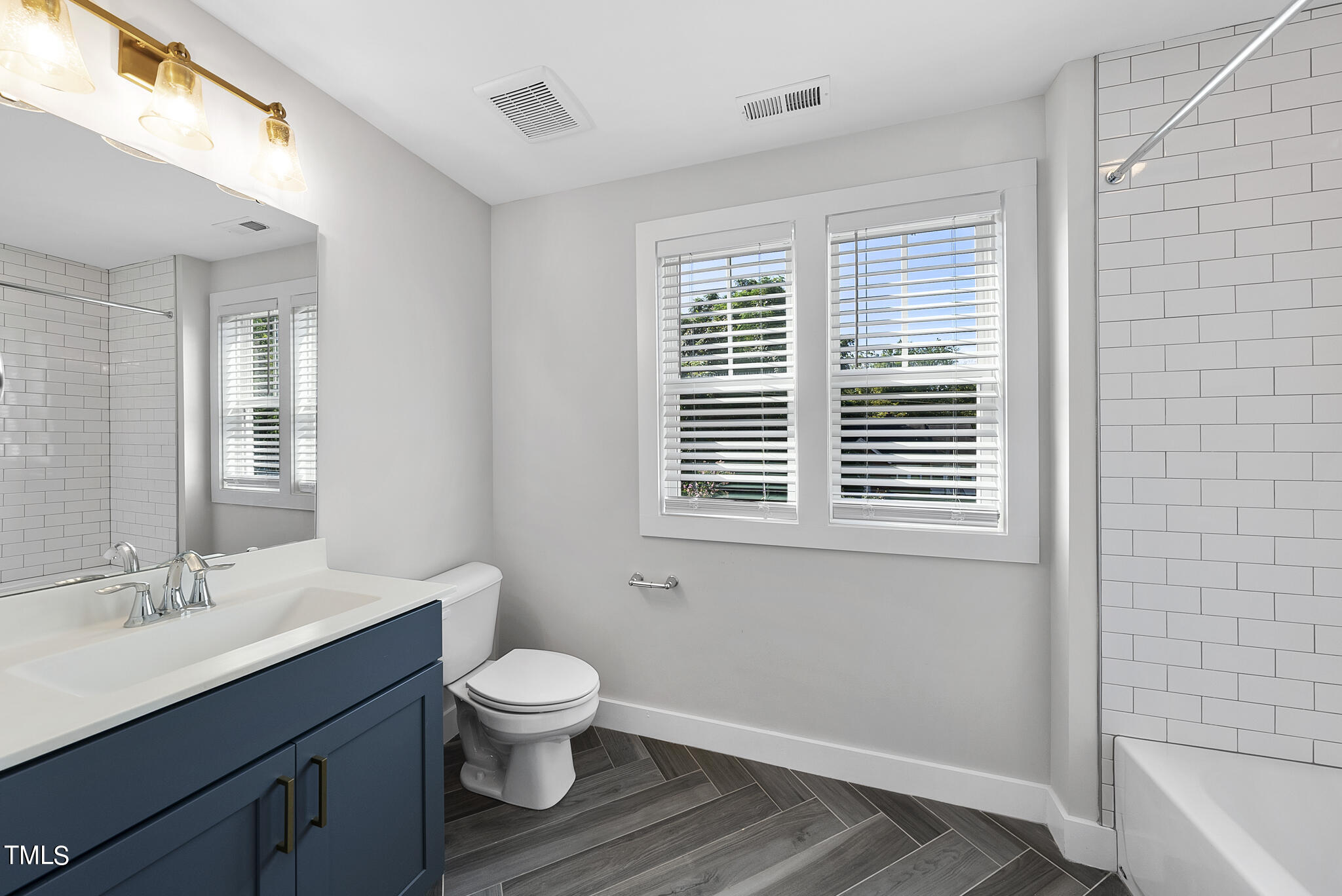421 Como Drive Raleigh, NC 27610 - Photo 20 of 28 a bathroom with a toilet a sink and a bathtub