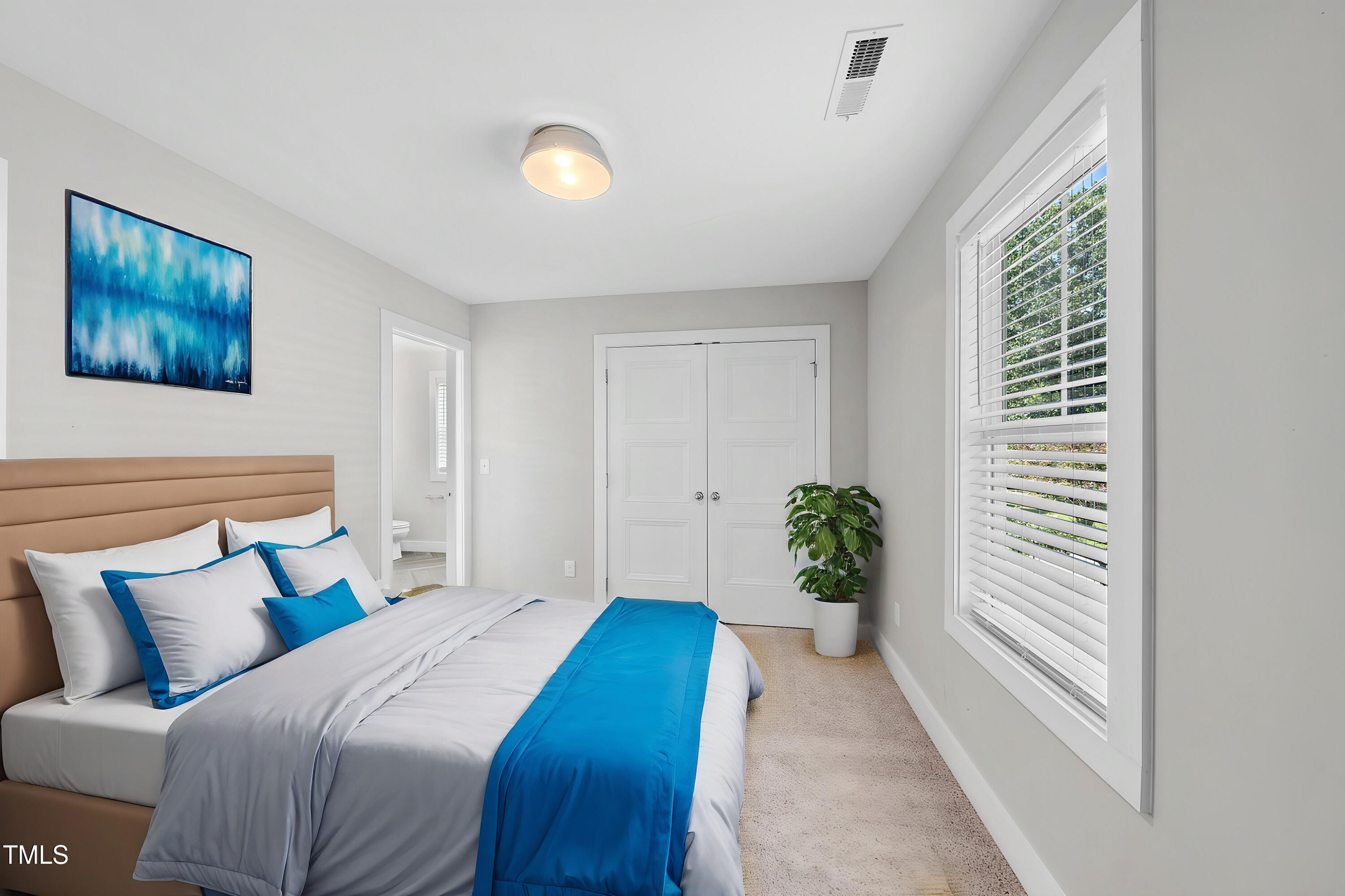 421 Como Drive Raleigh, NC 27610 - Photo 21 of 28 a bedroom with furniture and a potted plant