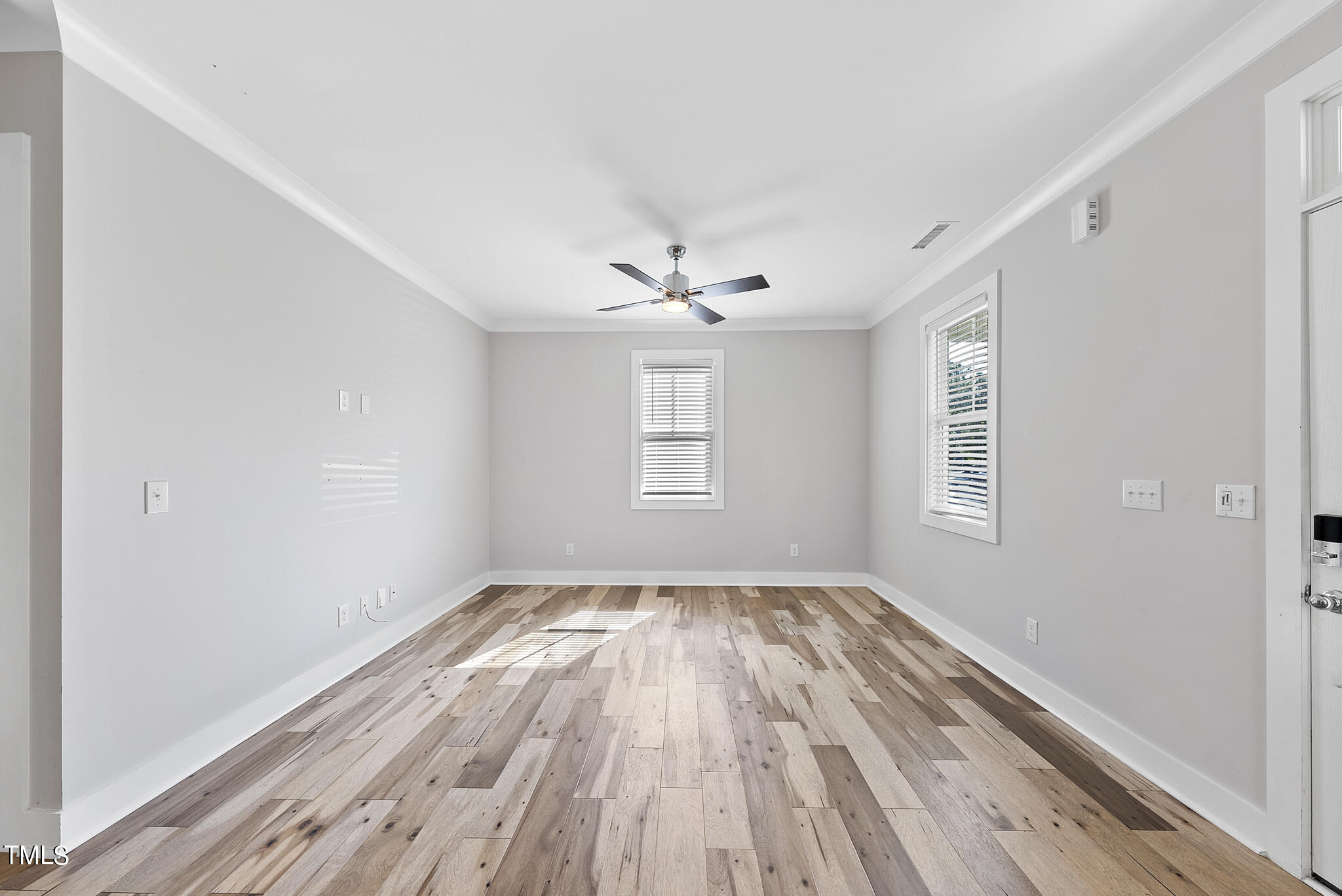 421 Como Drive Raleigh, NC 27610 - Photo 5 of 28 wooden floor in an empty room with a window