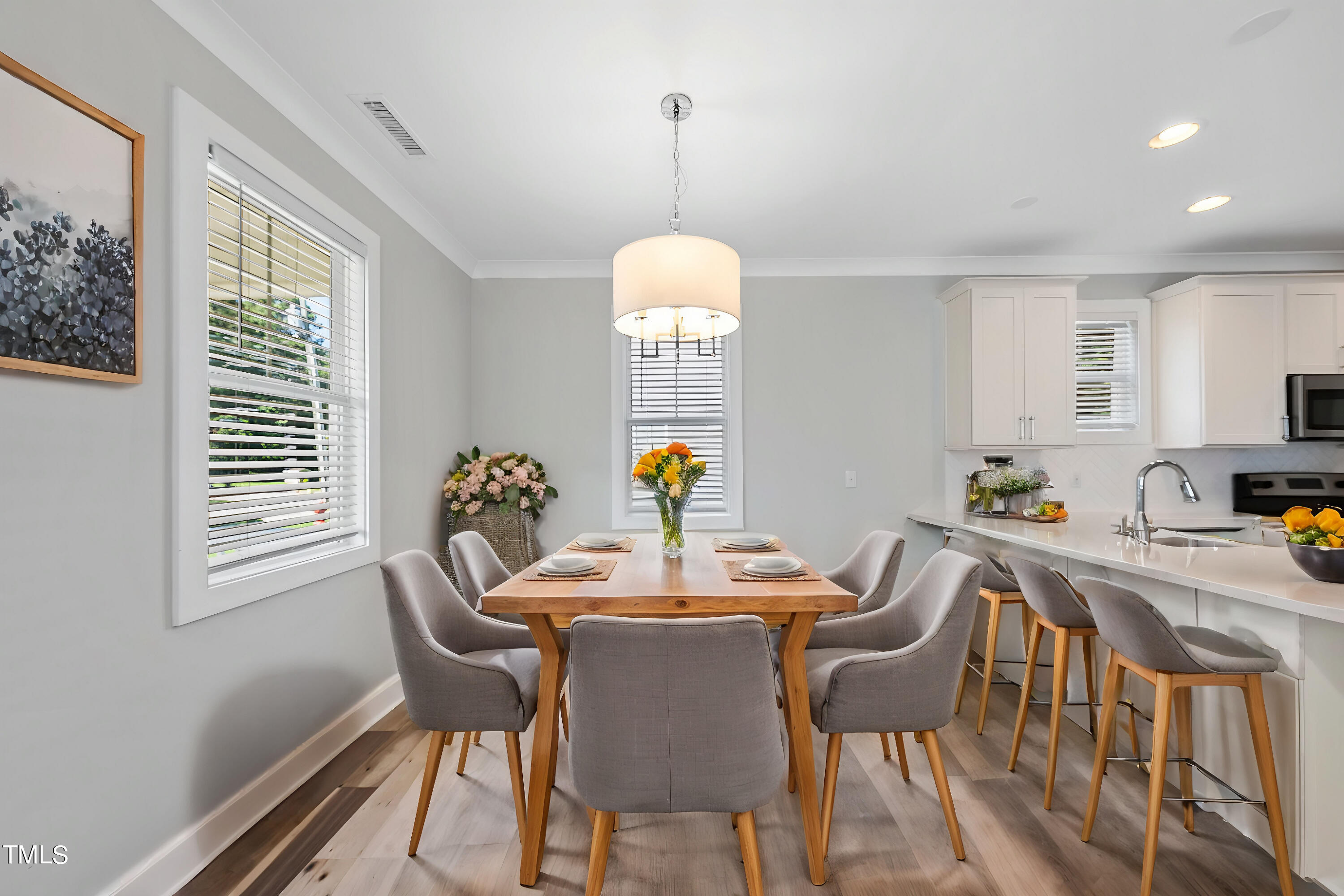 421 Como Drive Raleigh, NC 27610 - Photo 7 of 28 a dining room with furniture a chandelier and wooden floor