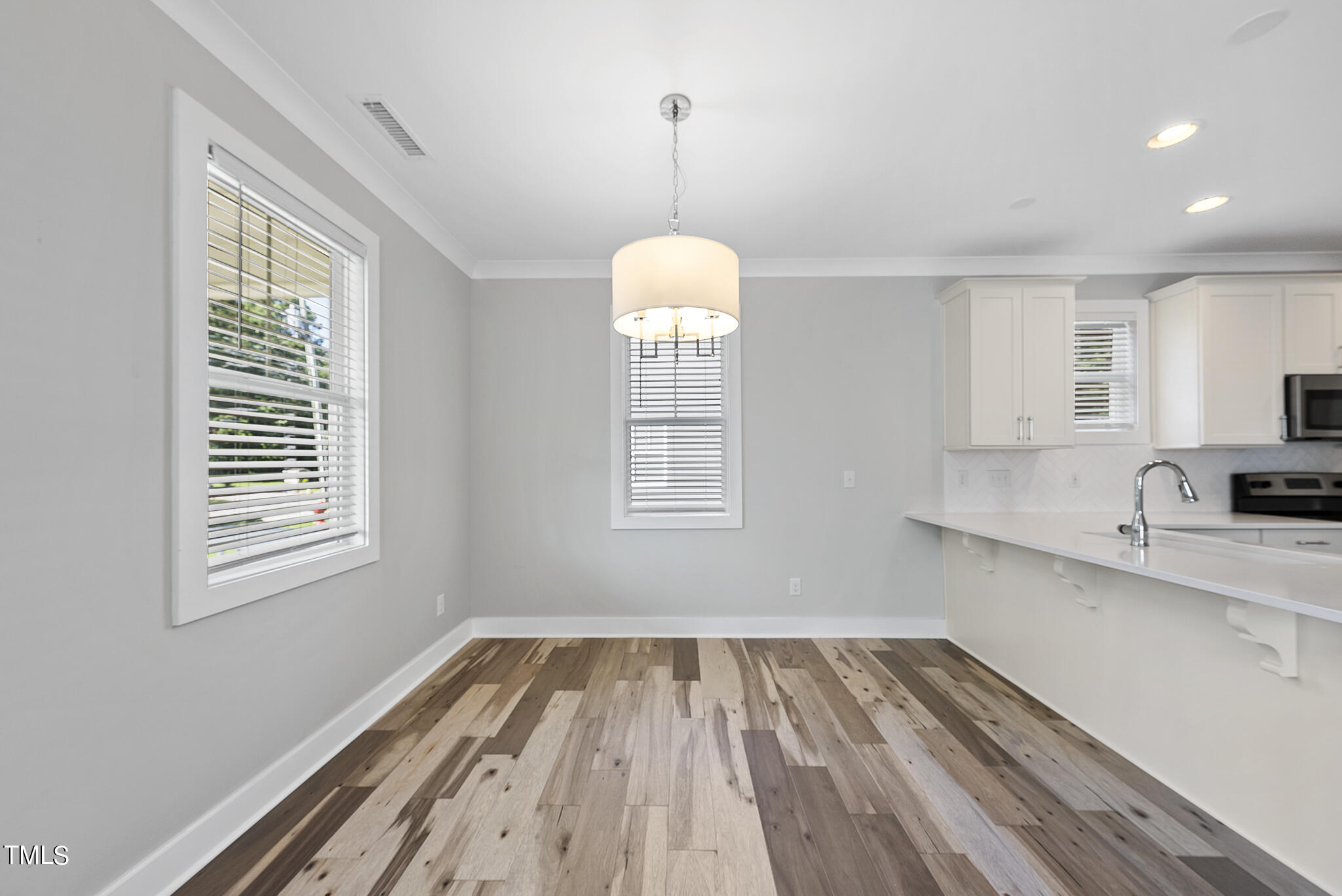 421 Como Drive Raleigh, NC 27610 - Photo 8 of 28 a view of a room with wooden floor and windows
