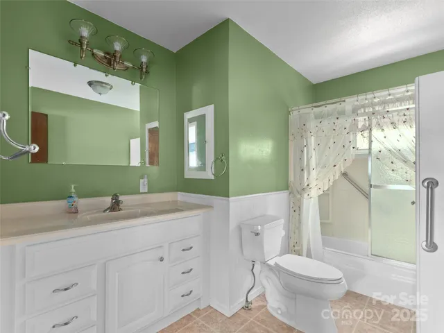 a bathroom with a double vanity sink mirror and toilet