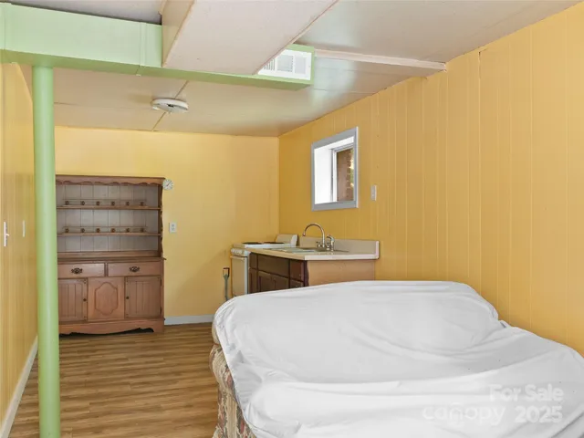 a bedroom with a bed and cabinet
