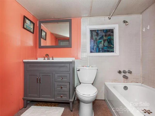 a bathroom with a toilet a sink and a bathtub