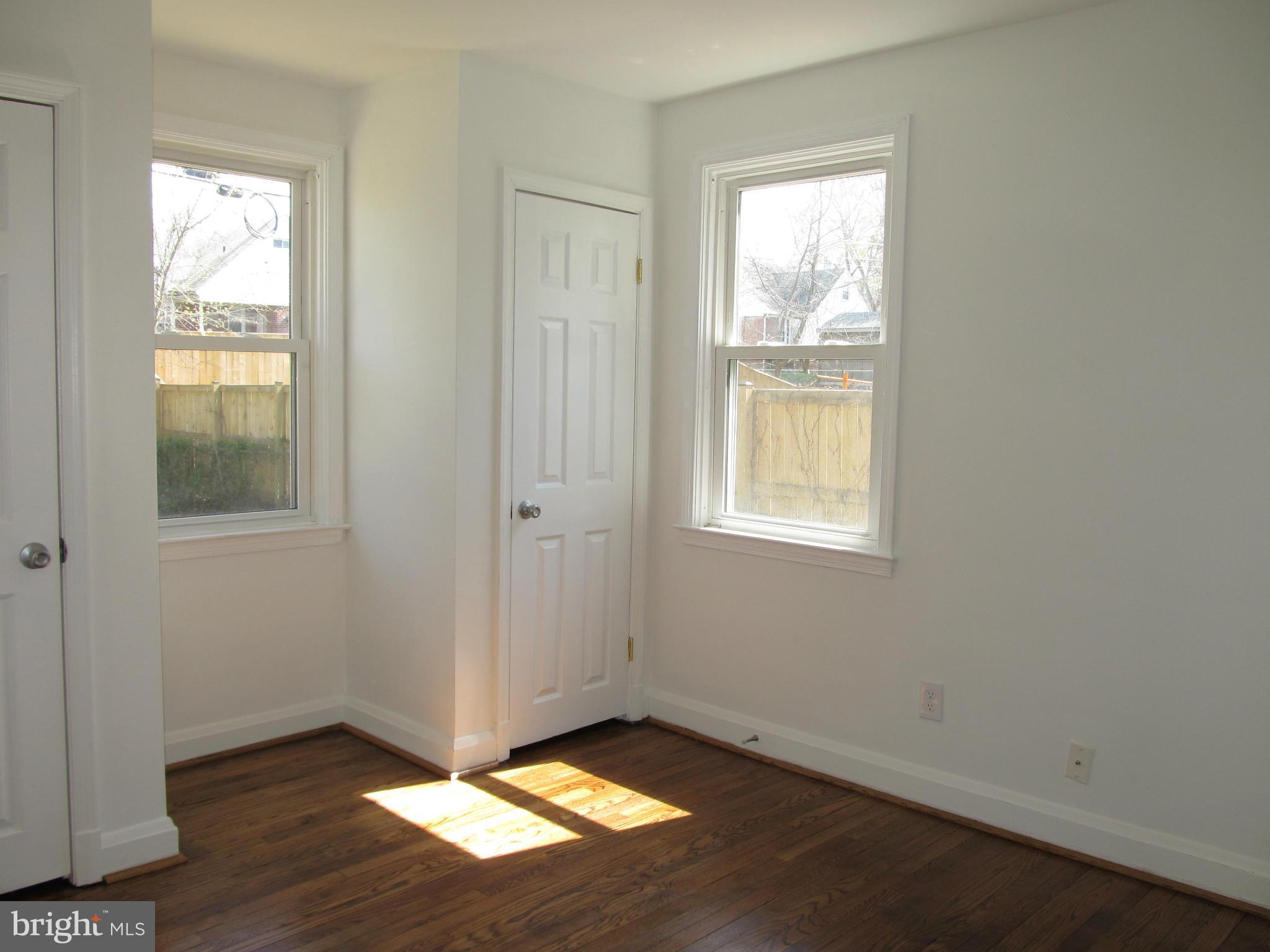 3507 Mayfair Road Baltimore, MD 21207 - Photo 14 of 30 an empty room with wooden floor closet and windows