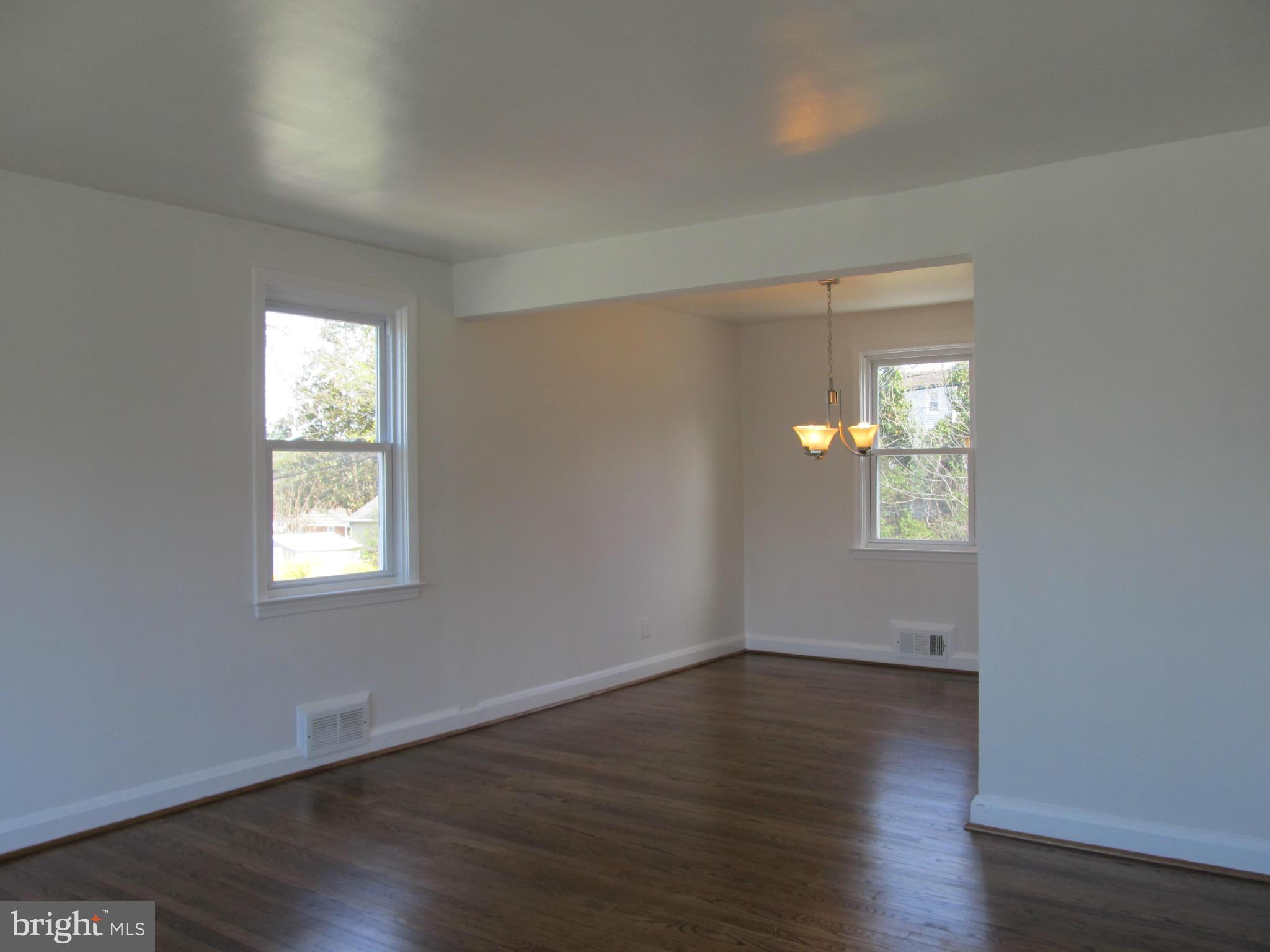 3507 Mayfair Road Baltimore, MD 21207 - Photo 5 of 30 a view of an empty room with wooden floor and a window