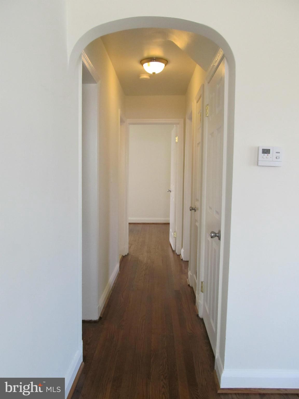 3507 Mayfair Road Baltimore, MD 21207 - Photo 8 of 30 a view of a hallway with wooden floor