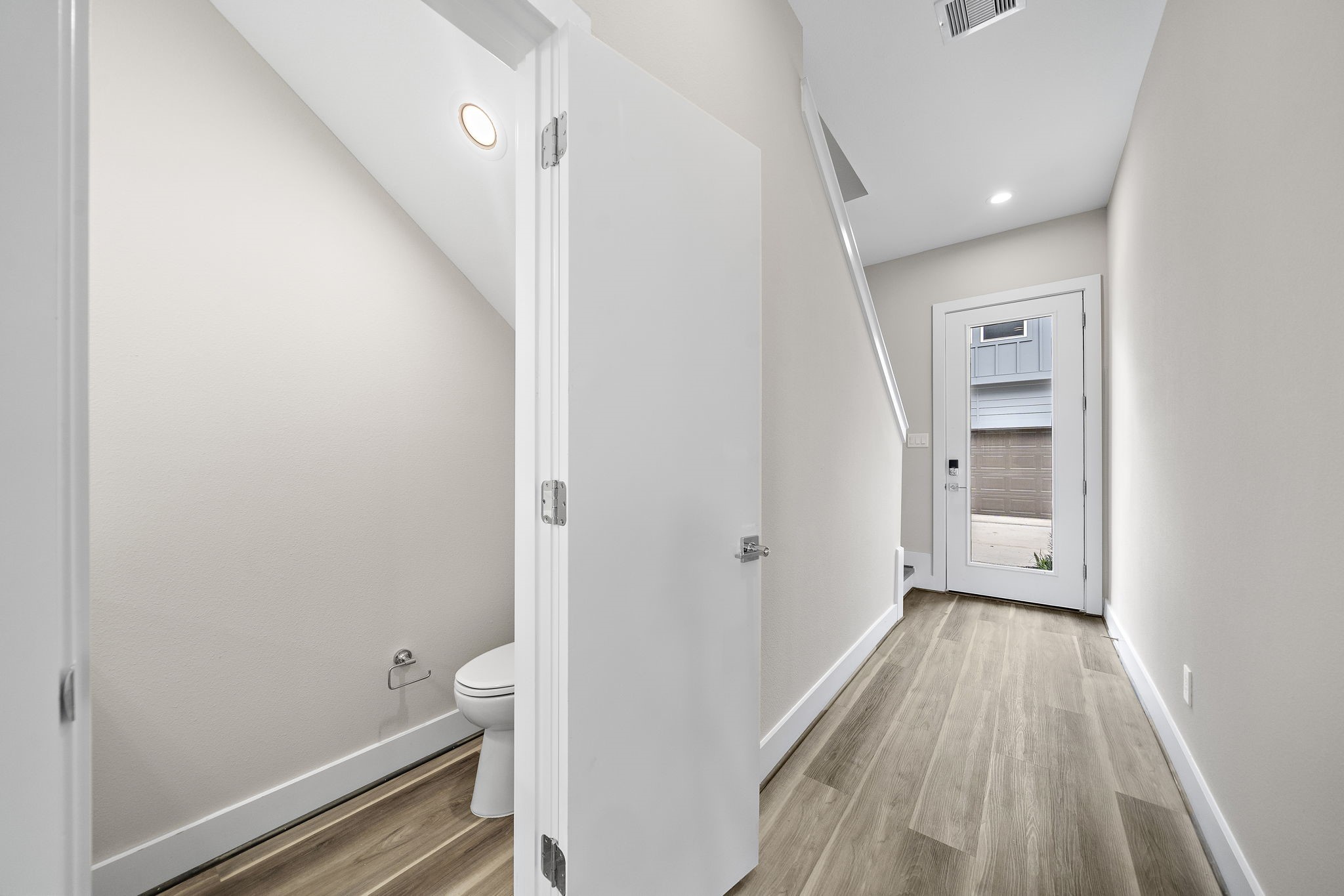 7522 Sandle Street Houston, TX 77088 - Photo 4 of 26 a view of a hallway view with wooden floor and a bathroom
