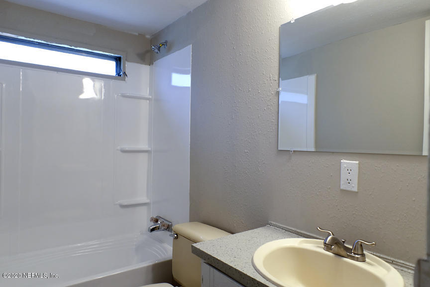 4075 Bronco Road Middleburg, FL 32068 - Photo 20 of 30 a bathroom with a granite countertop sink toilet and shower