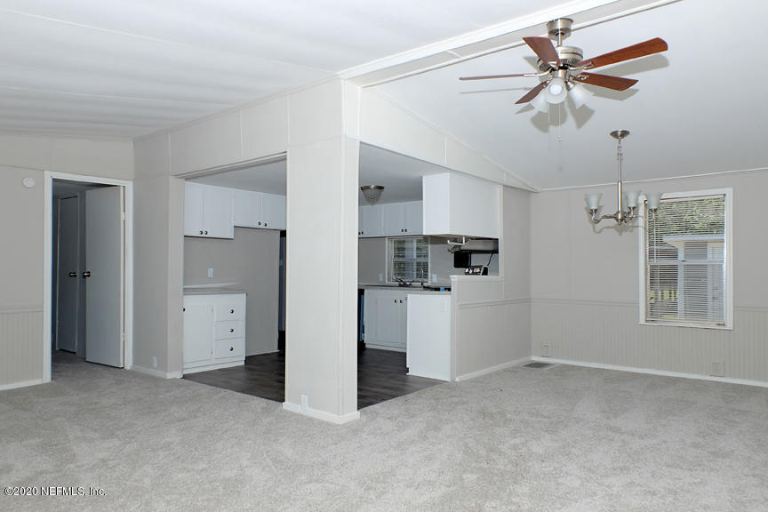 4075 Bronco Road Middleburg, FL 32068 - Photo 6 of 30 a view of a kitchen with a sink and a refrigerator