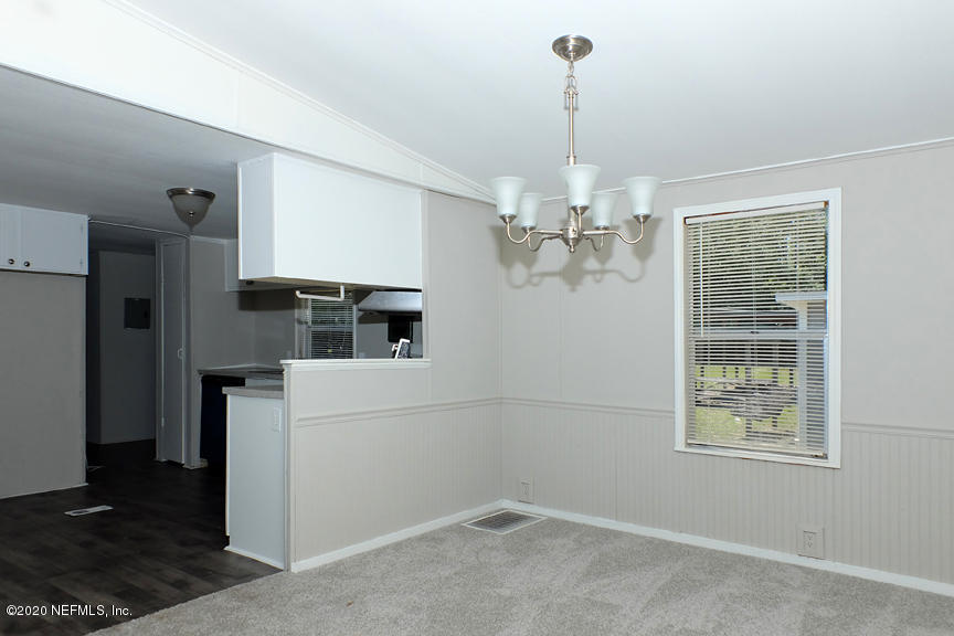 4075 Bronco Road Middleburg, FL 32068 - Photo 8 of 30 a kitchen view with a refrigerator and ceiling fan