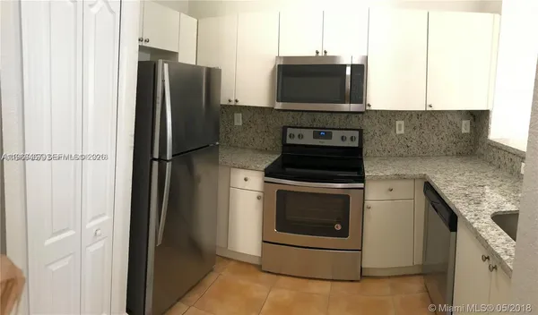a kitchen with a refrigerator stove and microwave
