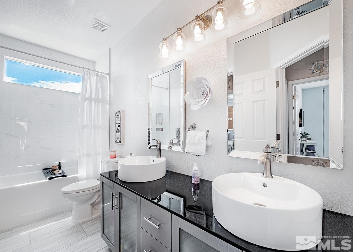 3095 Roxbury Drive Reno, NV 89523 - Photo 13 of 36 a bathroom with a double vanity sink mirror and toilet