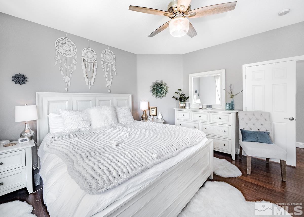 3095 Roxbury Drive Reno, NV 89523 - Photo 17 of 36 a bedroom with a bed and a chandelier
